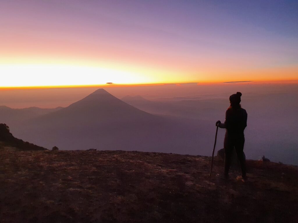 femme bloggueuse postant devant un volan au Guatemala au lever du soleil